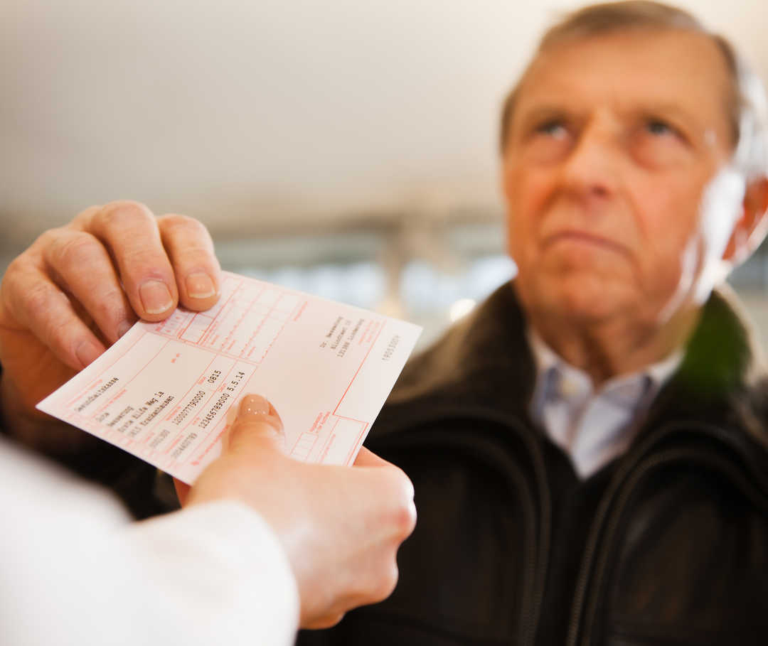 Mann löst ACE-Hemmer-Rezept in der Apotheke ein.